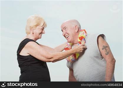 Woman putting a flower garland on husband