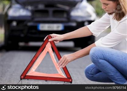 woman putting a safety red triangle