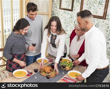 woman putting baked chicken festive table