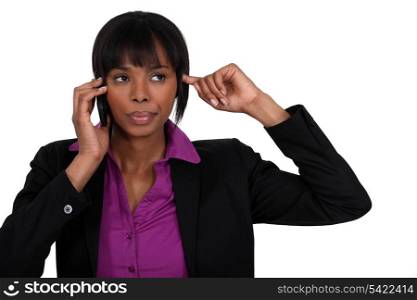 Woman putting finger in ear during call