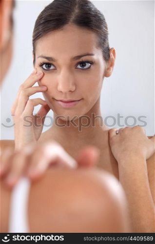 Woman putting in her contact lenses
