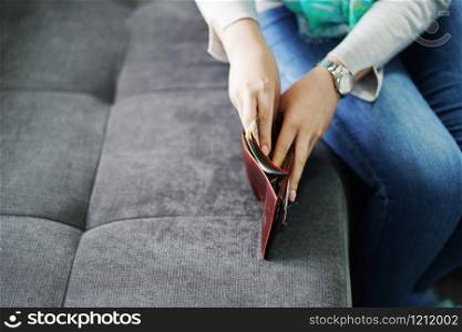 Woman putting money salary cash in the wallet taking from man husband