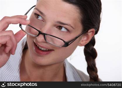 woman putting on her glasses