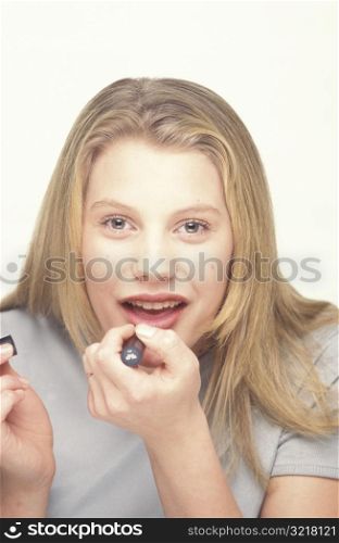 Woman Putting on Lipstick