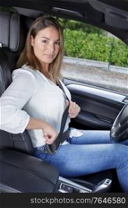 woman putting seat belt in car