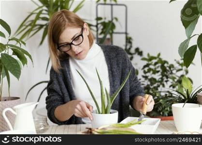 woman putting soil pot