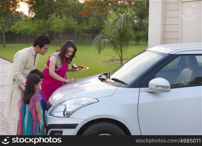 Woman putting tika on new car