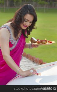 Woman putting tika on new car