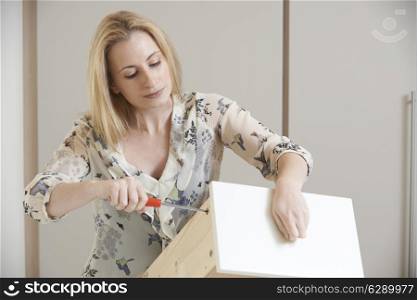 Woman Putting Together Self Assembly Furniture