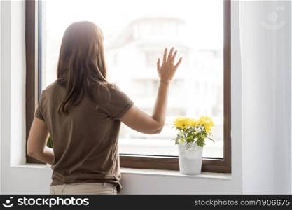 woman quarantine home looking through window. High resolution photo. woman quarantine home looking through window. High quality photo