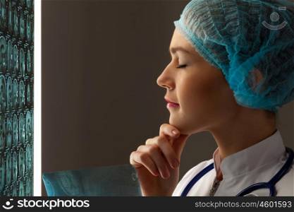 Woman radiologist. Image of attractive woman doctor in x-ray laboratory