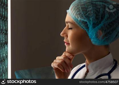 Woman radiologist. Image of attractive woman doctor in x-ray laboratory