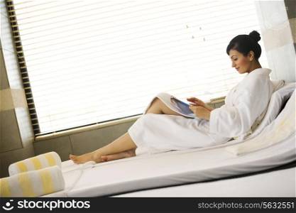 Woman reading a magazine at a spa