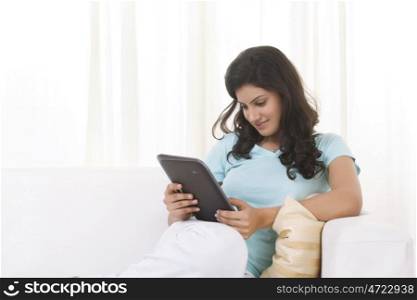 Woman reading an article on a digital tablet