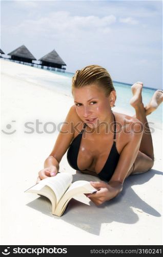 Woman reading at the beach