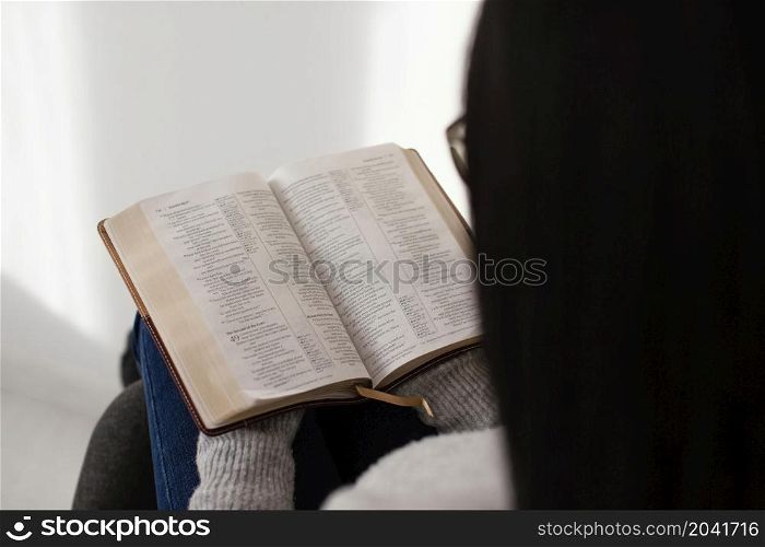 woman reading bible indoors