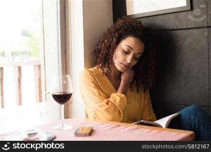 Woman reading book at coffee shop