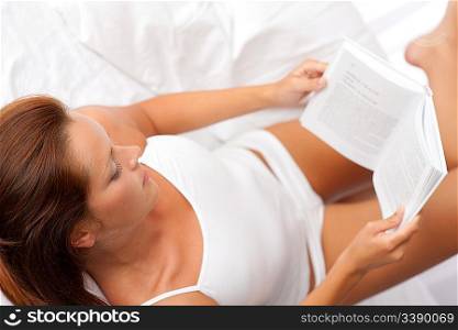 Woman reading book, shallow DOF