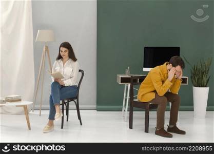 woman reading book while man is stressed