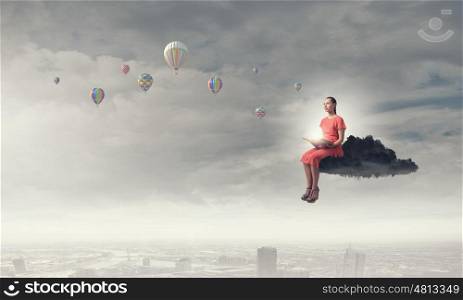 Woman reading book. Young woman in dress with old book in hand sitting on cloud