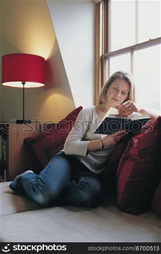 woman reading by the window