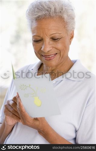 Woman reading card and smiling
