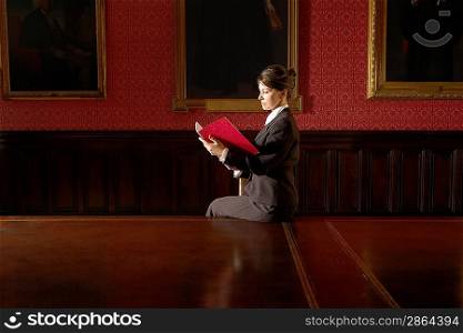 Woman Reading in Conference Room
