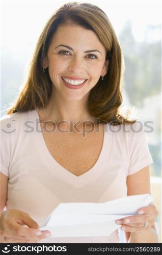 Woman reading letter smiling