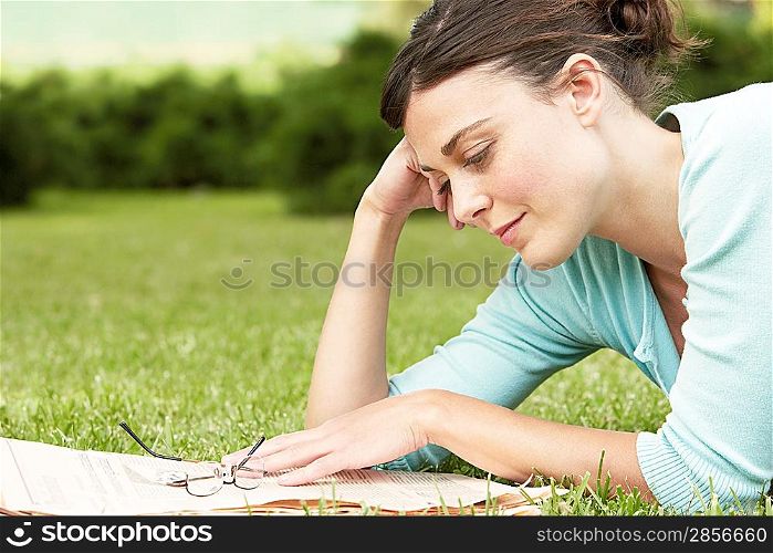 Woman Reading Newspaper in Park