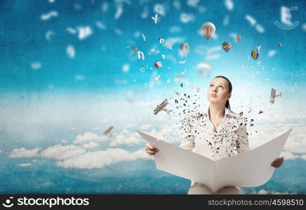 Woman reading newspaper. Portrait of young businesswoman in white suit reading blank newspaper