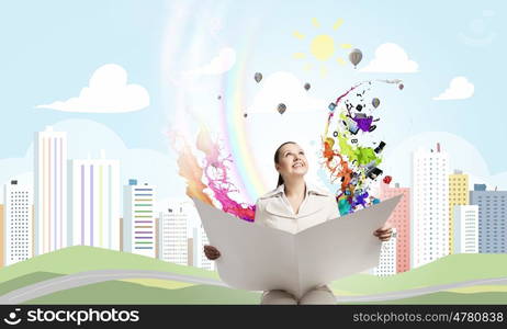 Woman reading newspaper. Portrait of young businesswoman in white suit reading blank newspaper