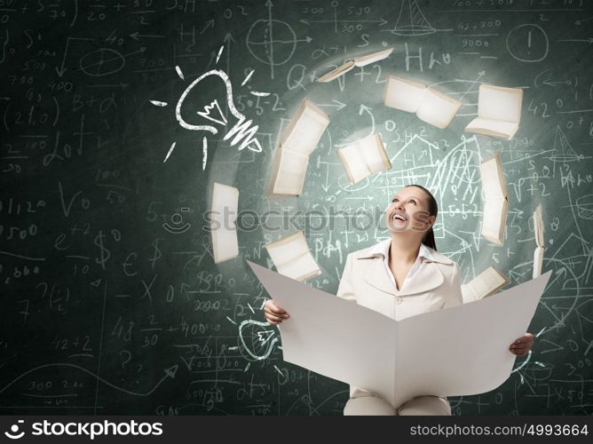 Woman reading newspaper. Portrait of young businesswoman in white suit reading blank newspaper