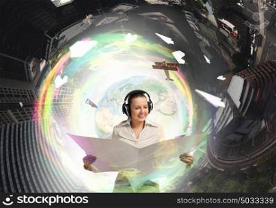Woman reading newspaper. Portrait of young businesswoman wearing headphones and reading blank newspaper