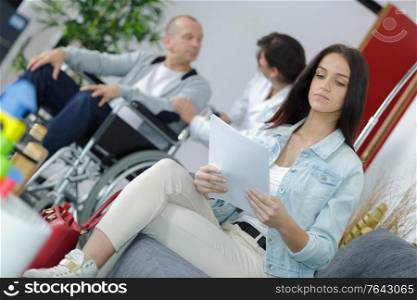 Woman reading paperwork in waiting room