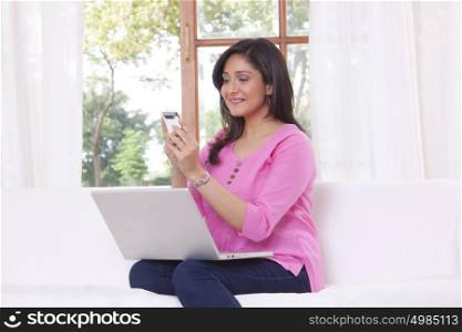 Woman reading sms on mobile phone