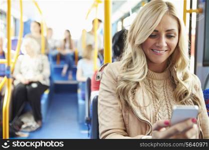Woman Reading Text Message On Bus