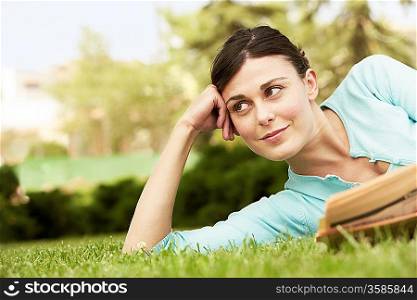 Woman Reading the Newspaper in the Grass
