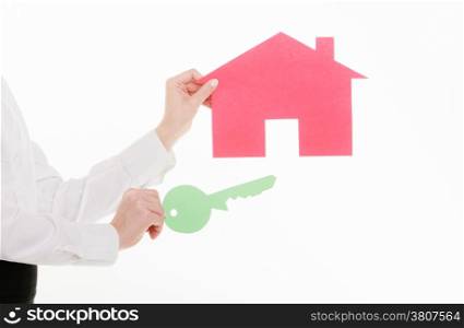 Woman real estate agent holding red paper house and key. Property business and accomodation or home buying ownership concept, isolated on white background