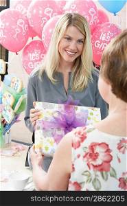 Woman Receiving a Gift at a Baby Shower