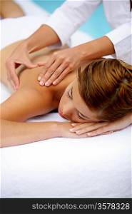 Woman receiving a poolside back massage