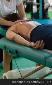Woman receiving Professional Massage by Therapist after Fitness Activity