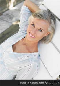 Woman reclining on sun lounger elevated view portrait