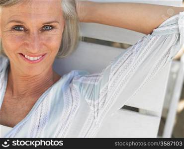 Woman reclining on sun lounger elevated view portrait close up