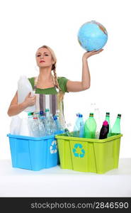 Woman recycling and holding planet earth in her hands