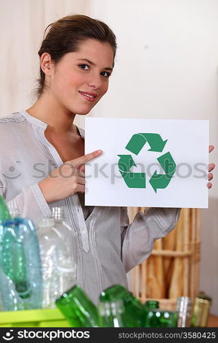 Woman recycling glass and plastic bottles