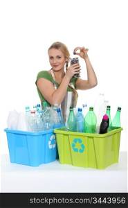 Woman recycling old plastic bottles