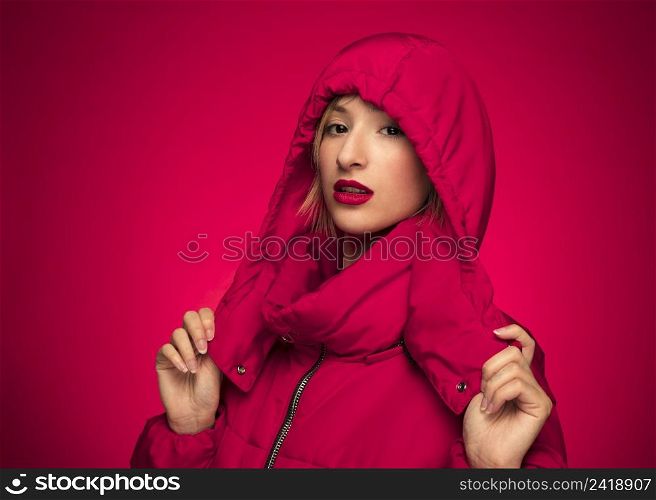 woman red winter hooded jacket purple background