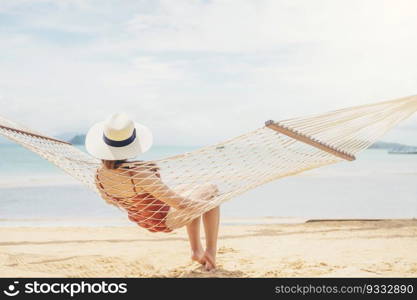 Woman relax on hammock beach in free time summer holiday