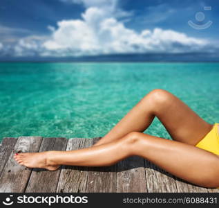 Woman relaxing at beach jetty