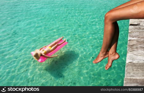 Woman relaxing at beach jetty